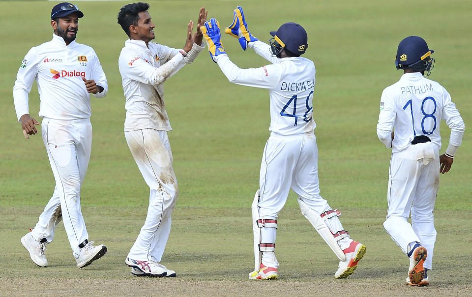 Sri Lanka's Praveen Jayawickrama, second left, celebrates with teammates the dismissal of Bangladesh's Mehidy Hasan during the third day of the second cricket test match between Sri Lanka and Bangladesh in Pallekele, Sri Lanka, Sunday, May 01, 2021.( AP Photo/Sameera Peiris)