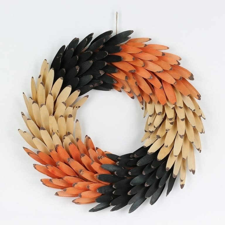 the orange, black and wooden wreath