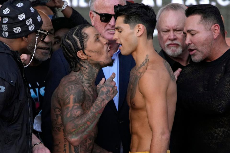 Gervonta Davis, center left, and Ryan Garcia speak during a weigh-in Friday, April 21, 2023, in Las Vegas. The two are scheduled to fight in a catchweight boxing bout in Las Vegas on Saturday. (AP Photo/John Locher)