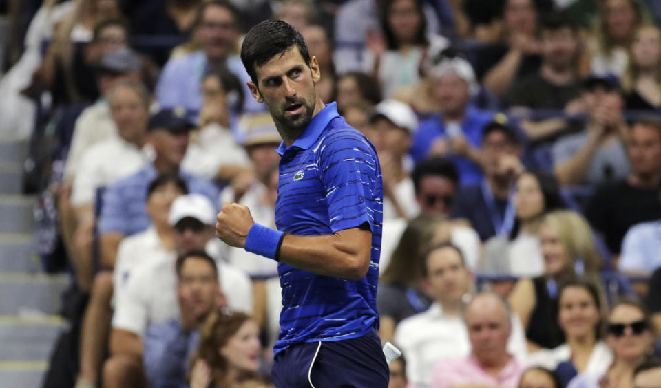 Novak Djokovic, of Serbia, pumps his fist as he looks back toward his coach after winning a point against Denis Kudla during the third round of the U.S. Open tennis tournament Friday, Aug. 30, 2019, in New York. (AP Photo/Charles Krupa)