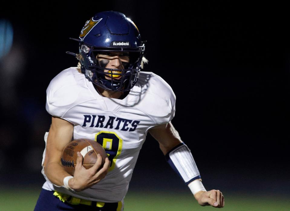 Pewamo-Westphalia's Dylan May runs against Lansing Catholic, Friday, Oct. 21, 2022, in Lansing. Lansing Catholic won 42-7.