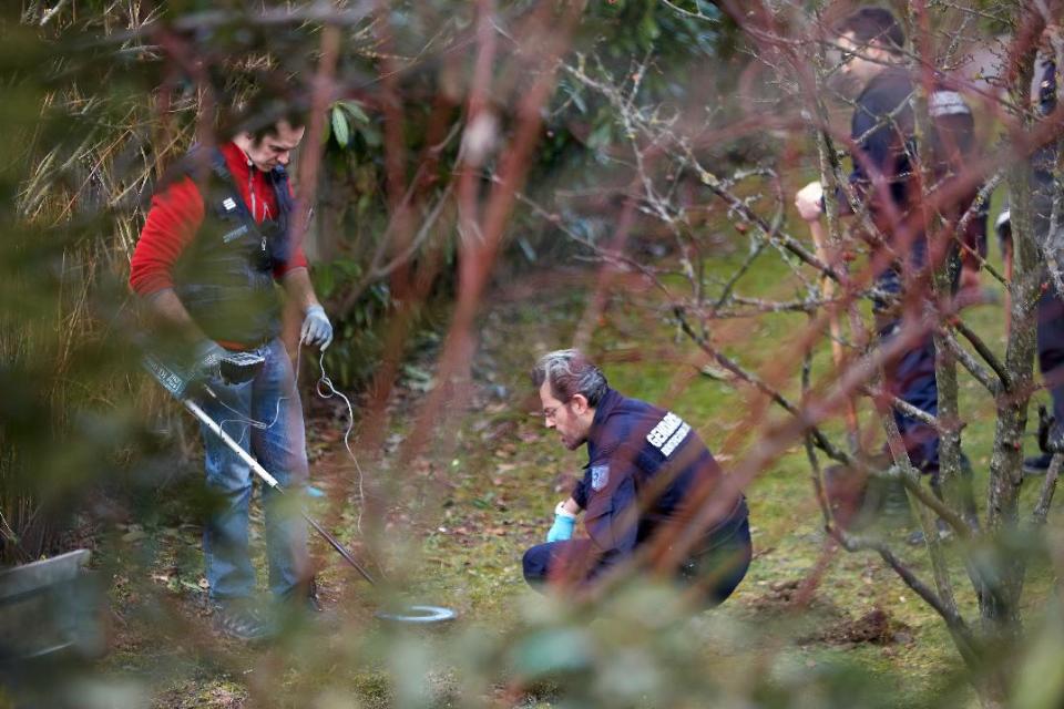 French police search for clues in a residential area in Talloires, French Alps, Tuesday, Feb. 18, 2014, as part of a continuing investigation into the grisly shooting deaths of a British-Iraqi man and three others nearly 18-months ago. French police announced Tuesday they have detained a 48-year old man, a resident of eastern France, in connection with the deaths. (AP Photo)