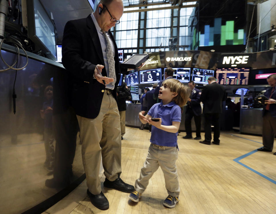 Tripp Mancuso, 4, works with his trader father Peter Mancuso on the floor of the New York Stock Exchange, during the NYSE Working Parents/Caregivers Employee Resource Group's annual Take Your Child to Work Day program, Thursday, April 24, 2014. Mixed earnings from a large number of U.S. companies left the stock market without direction early Thursday, despite positive results from a handful of names including Apple and Caterpillar. (AP Photo/Richard Drew)