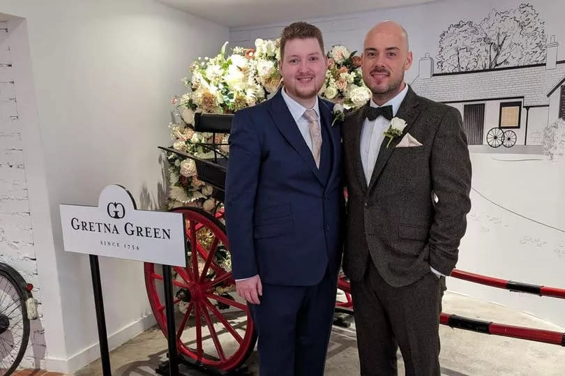 Mike with his husband James in suits