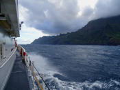 In this photo released by the U.S. Coast Guard, Coast Guard Cutter William Hart moves toward the Na Pali Coast on the Hawaiian island of Kauai on Friday, Dec. 27, 2019, the day after a tour helicopter disappeared with seven people aboard. Authorities say wreckage of the helicopter has been found in a mountainous area on the island. (Lt. j.g. Daniel Winter/U.S. Coast Guard via AP)