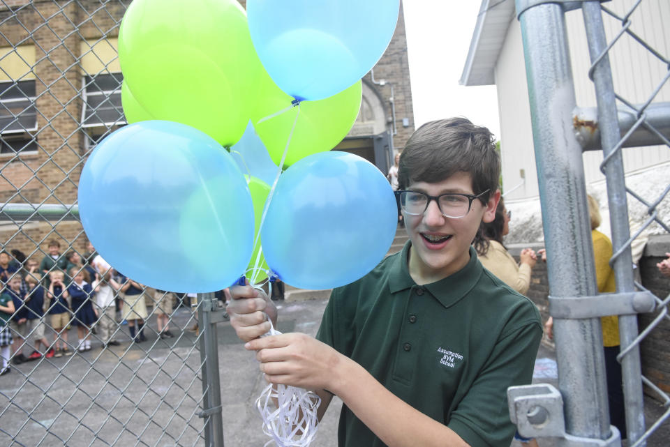 Andrew Smith, eighth-grade student at Assumption BVM School in Pottsville, Pa., departs the school yard after his surpise send-off for his departure to the National Spelling Bee on Thursday, May 26, 2022. Smith won the 66th Regional Spelling Bee competition in March. (Jacqueline Dormer/Republican-Herald via AP)