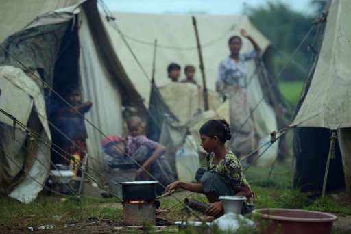 A Muslim Rohingya woman prepares food outside her tent at the Dabang Internally Displaced Persons camp, on the outskirts of Sittwe, capital of Myanmar's western Rakhine state. New clashes laid bare festering tensions between the two communities after widespread violence in June left dozens dead, tens of thousands displaced and prompted rights groups to warn of a humanitarian crisis