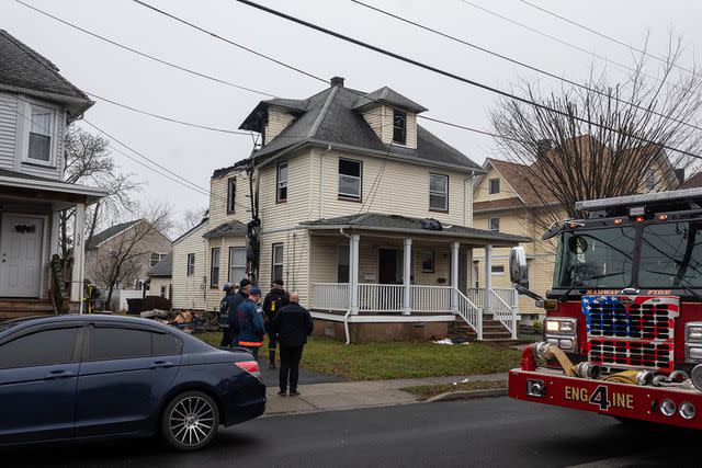 <p>Brian Branch Price/ZUMA Press Wire/SplashNews</p> Fire officials inspect the results of a house fire that broke out in a two-story, two-family home early on Jan 26, 2024.