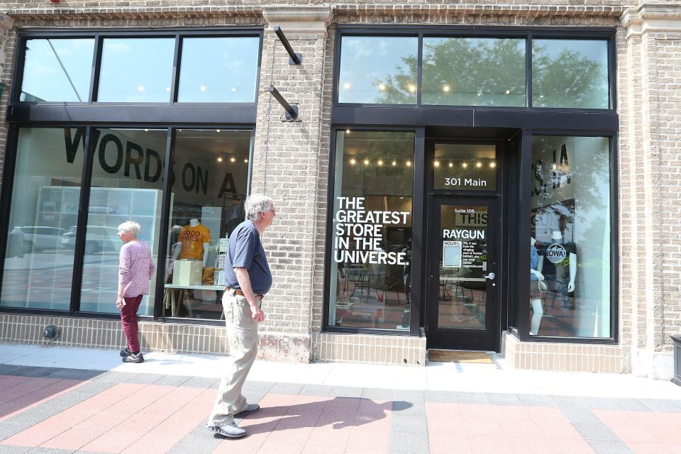 People look around the display at the storefront of Raygun that opened Friday in downtown Ames on Main Street, Wednesday, June 28, 2023, in Ames, Iowa.