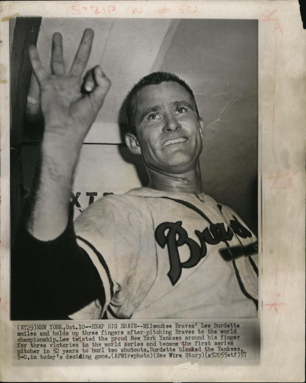 Lew Burdette holds up three fingers for the three wins he racked up in the 1957 World Series after he helped the Milwaukee Braves win the championship.