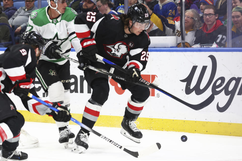 Buffalo Sabres defenseman Owen Power (25) carries the puck behind the net during the first period of the team's NHL hockey game against the Dallas Stars on Tuesday, Feb. 6, 2024, in Buffalo, N.Y. (AP Photo/Jeffrey T. Barnes)