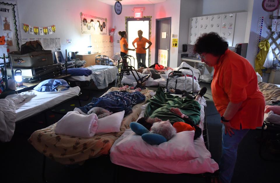 Kim Pestana, right, a staff member from Plymouth Harbor, checks on a resident from the senior living facility at a hurricane shelter set up at Phillippi Shores Elementary School in Sarasota, the day before Hurricane Ian struck Southwest Florida. Sarasota was spared the worst, but parts of the county still suffered significant damage.