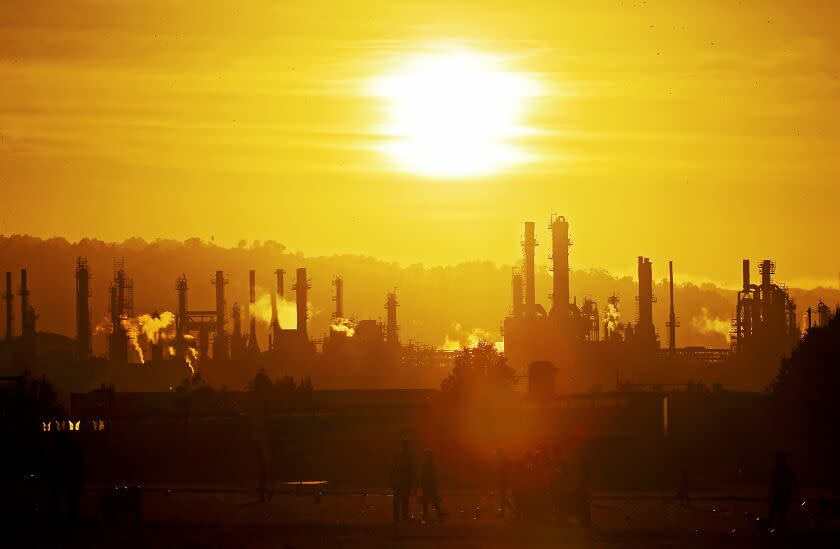 LOS ANGELES, CALIF. - OCT. 4, 2022. Youth soccer teams practice at Wilmington Waterfront Park in the shadow of the Conoco Phillips refinery. (Luis Sinco / Los Angeles Times)