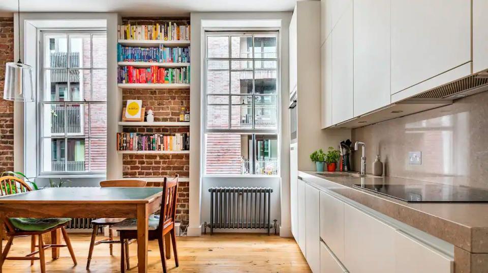 a kitchen with a table and chairs