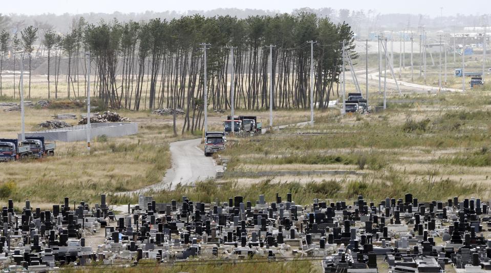 In this Oct. 10, 2012 photo, grave stones stand in a cemetery near pine trees, part of breakwater forest, that survived the March 11, 2011 earthquake and tsunami, near the Arahama beach in Sendai, northeastern Japan. Japan's accounting of its budget for reconstruction from the disasters is crammed with spending on unrelated projects, while all along Japan's northeastern coast, dozens of communities remain uncertain of whether, when and how they will rebuild. (AP Photo/Koji Sasahara)