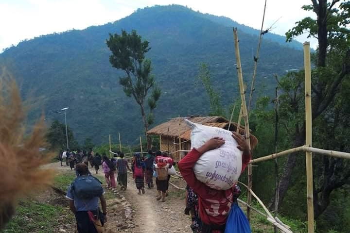 FILE PHOTO: People displaced by fighting in north-western Myanmar between junta forces and anti-junta fighters walk in Chin State