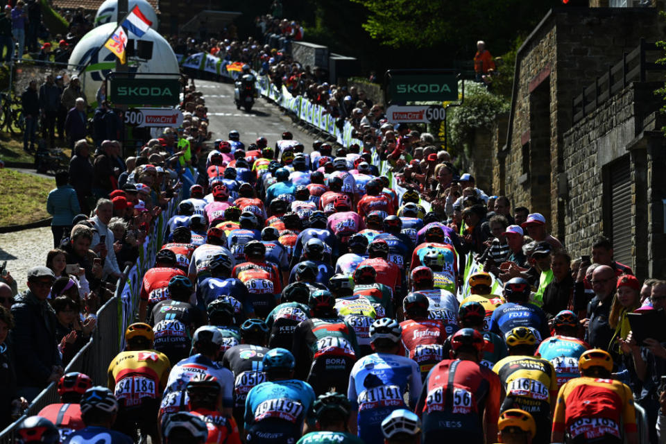 HUY BELGIUM  APRIL 19 A general view of the peloton climbing to the Wall of Geraardsbergen  Mur de Huy 204m while fans cheer during the 87th La Fleche Wallonne 2023 Mens Elite a 1943km one day race from Herve to Mur de Huy  UCIWT  on April 19 2023 in Huy Belgium Photo by Luc ClaessenGetty Images