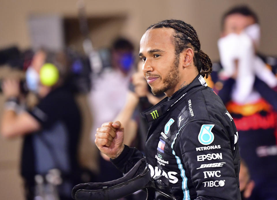 FILE - In this Sunday, Nov. 29, 2020 file photo, Mercedes driver Lewis Hamilton of Britain celebrates after wining the Formula One race in Bahrain International Circuit in Sakhir, Bahrain. Hamilton is now a “Sir” as well as a seven-time Formula One champion after being knighted Wednesday, Dec. 30 in Queen Elizabeth II’s New Year honors list. The awards also recognize British performers, politicians and public servants, as well as people outside the limelight who have worked to defeat the coronavirus and its devastating impact. (Giuseppe Cacace, Pool via AP, File)