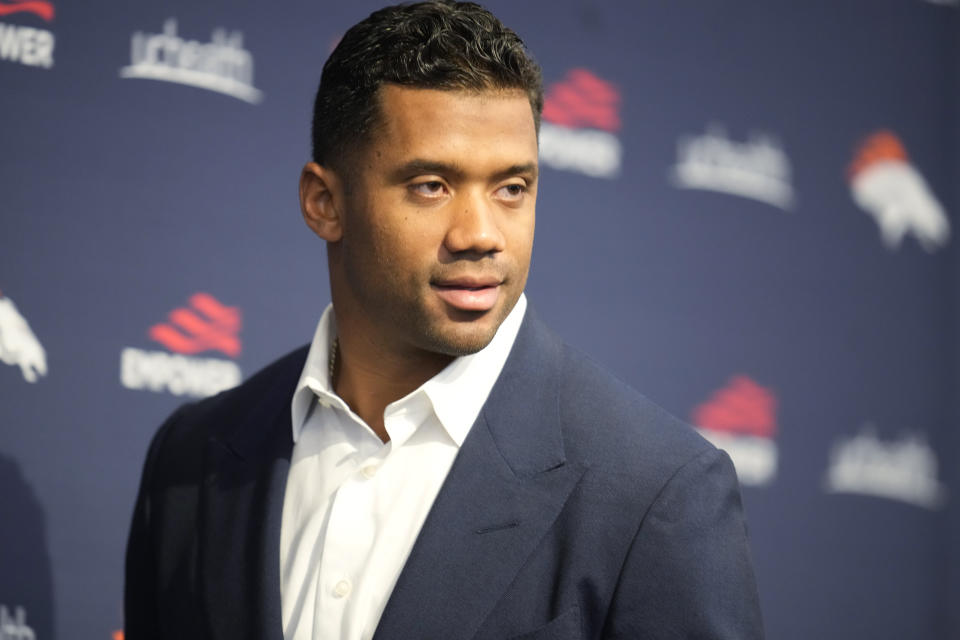 Denver Broncos quarterback Russell Wilson enters a news conference to announce that Wilson had signed a five-year contract extension worth $245 million, Thursday, Sept. 1, 2022, at the NFL football team's headquarters in Centennial, Colo. (AP Photo/David Zalubowski)