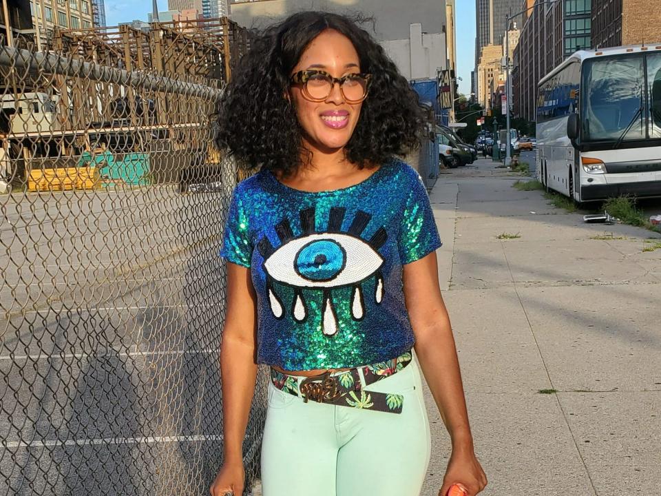 sandra wearing a blue sequined top with an eye on it