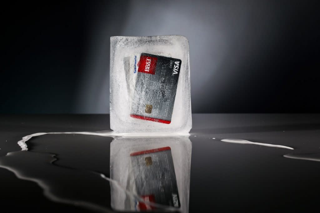 Two credit cards are encased in ice.