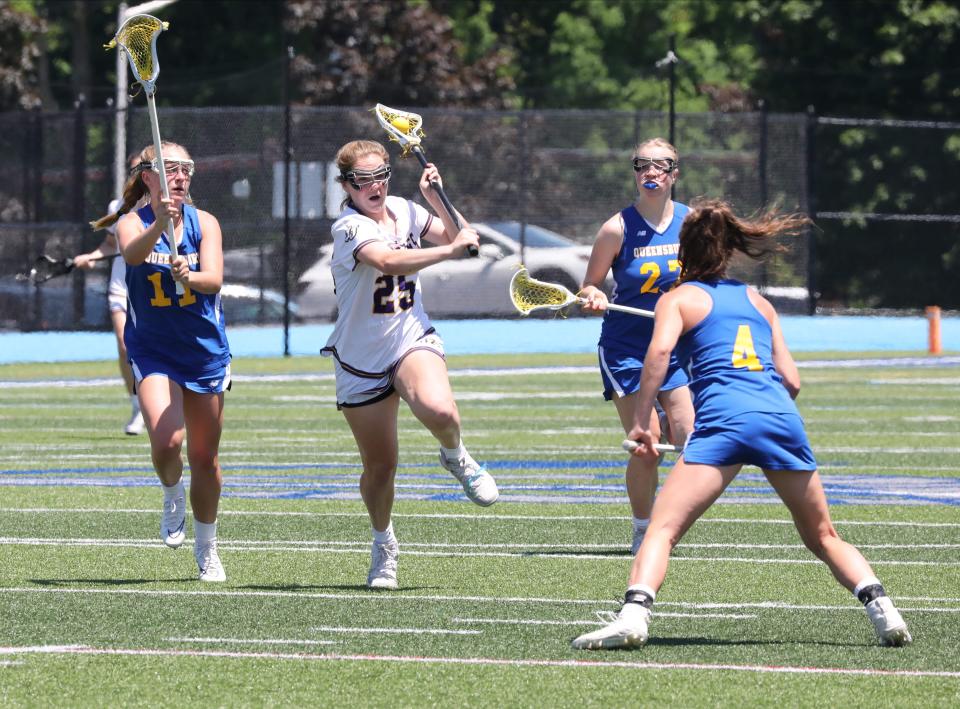 John Jay's Annabel Brennan is defended by Queensbury defenders during their girls lacrosse Class B state regional final at Hendrick Hudson High School in Montrose, June 4, 2022. 