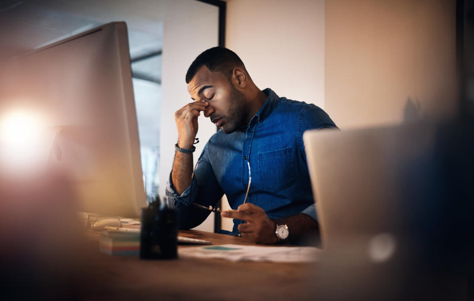 a man looking tired at a computer