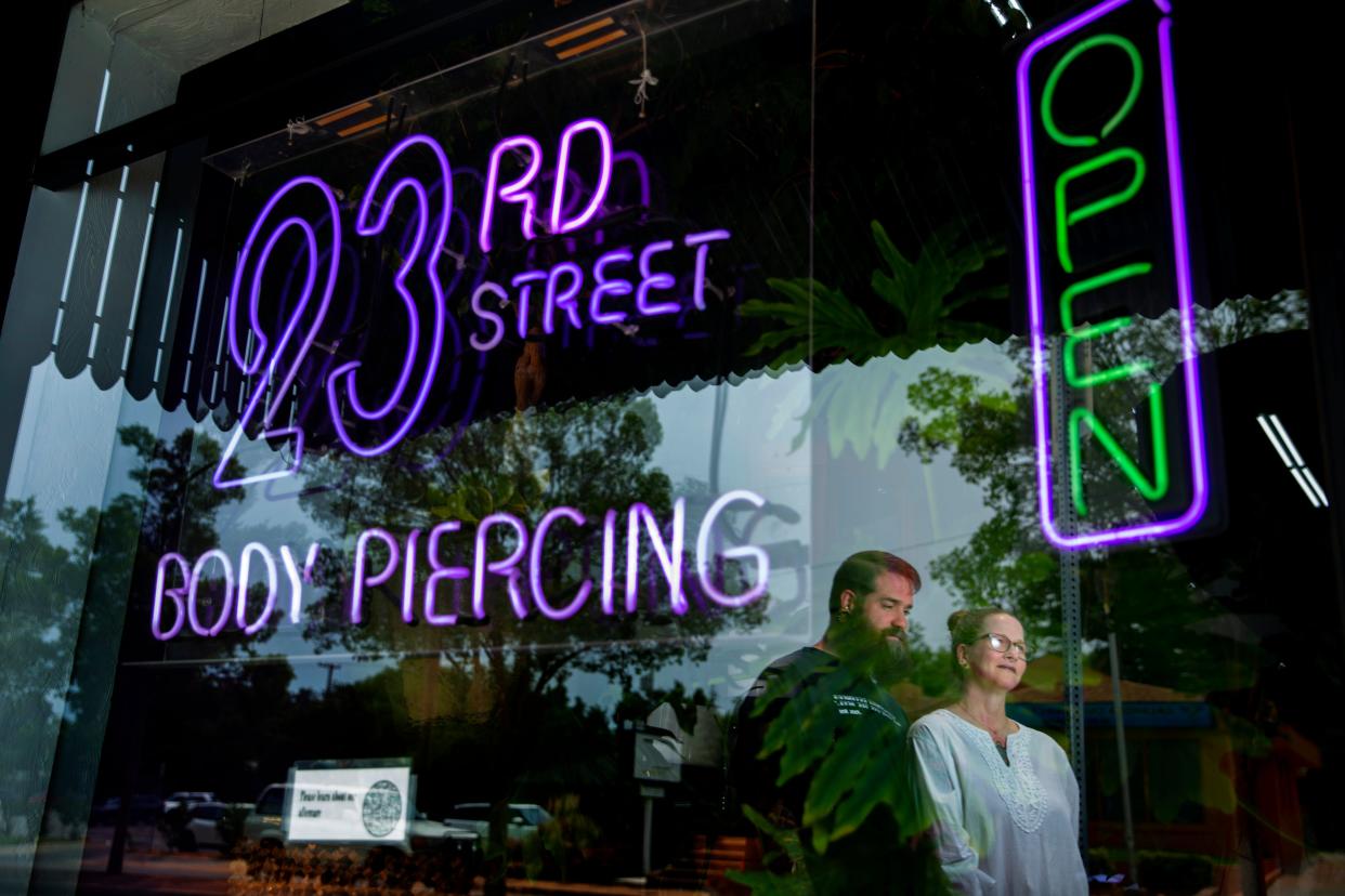 Owners of 23rd Street Body Piercing and Atomic Lotus Tattoo, Jason and Tisha King pose for a photo outside their stores in Oklahoma City, Tuesday, May 17, 2022. 