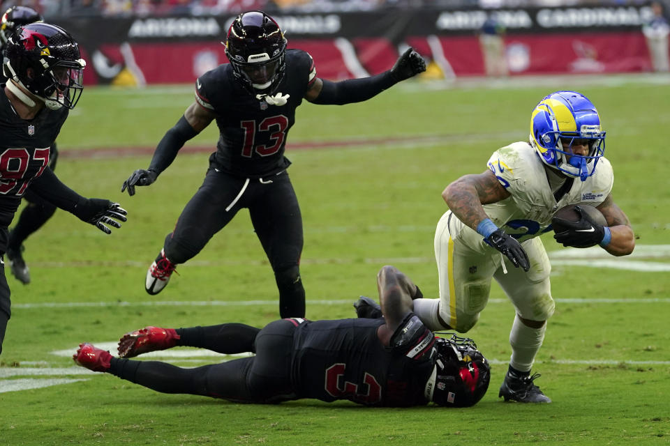 Los Angeles Rams running back Kyren Williams, right, tries to get away from Arizona Cardinals safety Budda Baker (3) and others during the second half of an NFL football game, Sunday, Nov. 26, 2023, in Glendale, Ariz. (AP Photo/Matt York)