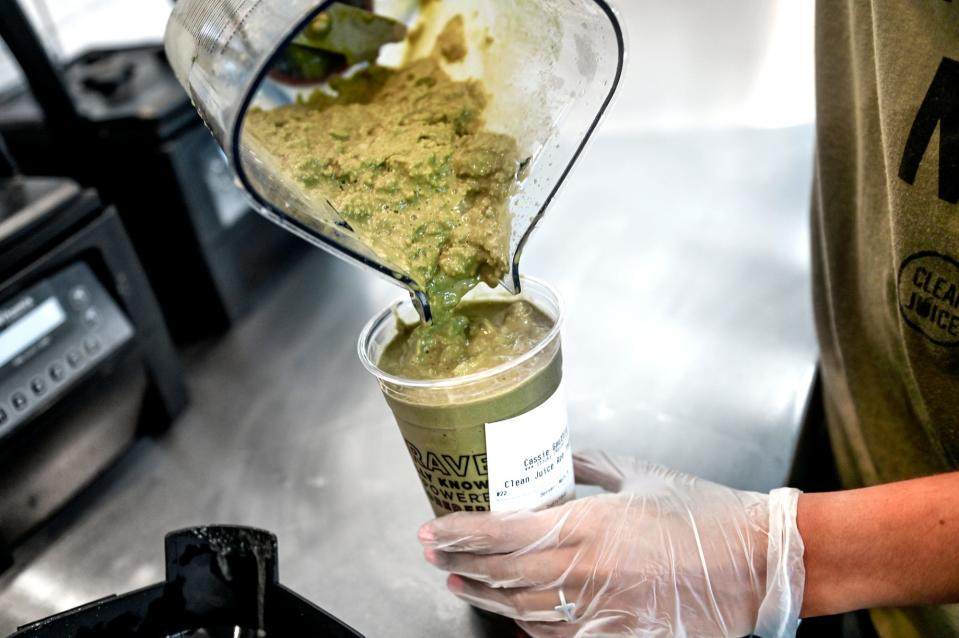 Clean Juice employee Harley Haines makes a drink for a customer at the store in East Lansing, Michigan, on Sept. 21. Clean Juice plans to open a new location in Pensacola.