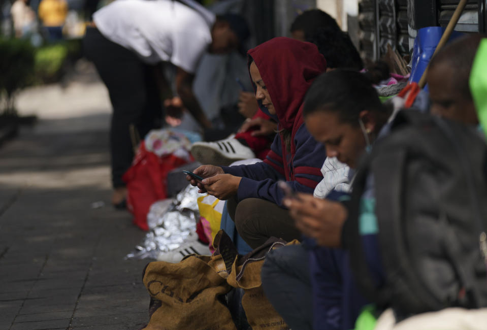 Venezuelan migrants wait for assistance outside of the Mexican Commission for Refugee Aid in Mexico City, Thursday, Oct. 20, 2022. This group of migrants interrupted their trek in Mexico City after the U.S. announced that Venezuelans who walk or swim across the border will be immediately returned to Mexico without the right to seek asylum. (AP Photo/Fernando Llano)