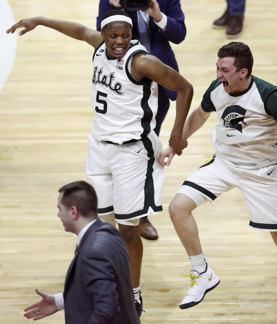 Michigan State guards Cassius Winston (5) and Foster Loyer celebrate the team's 75-63 win over Michigan in an NCAA college basketball game Saturday, March 9, 2019, in East Lansing, Mich. (AP Photo/Carlos Osorio)