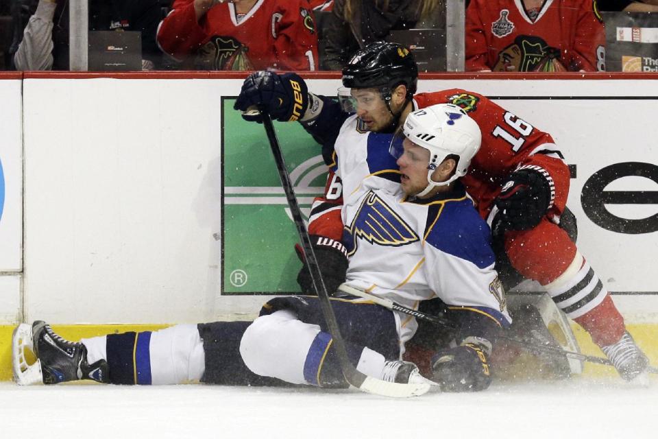 St. Louis Blues' Vladimir Sobotka (17) is checked by Chicago Blackhawks' Marcus Kruger (16) during the first period in Game 6 of a first-round NHL hockey playoff series in Chicago, Sunday, April 27, 2014. (AP Photo/Nam Y. Huh)