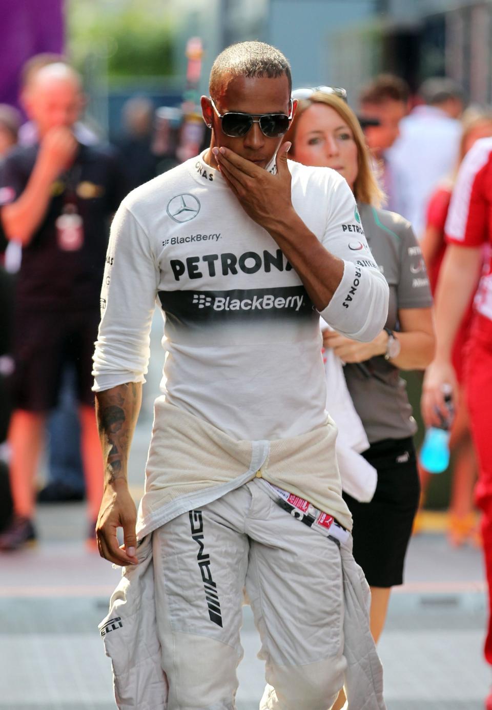 Mercedes' Lewis Hamilton makes his way back to the garage after going out in Q2 during qualifying day for the 2013 Italian Grand Prix at the Autodromo di Monza in Monza, Italy.