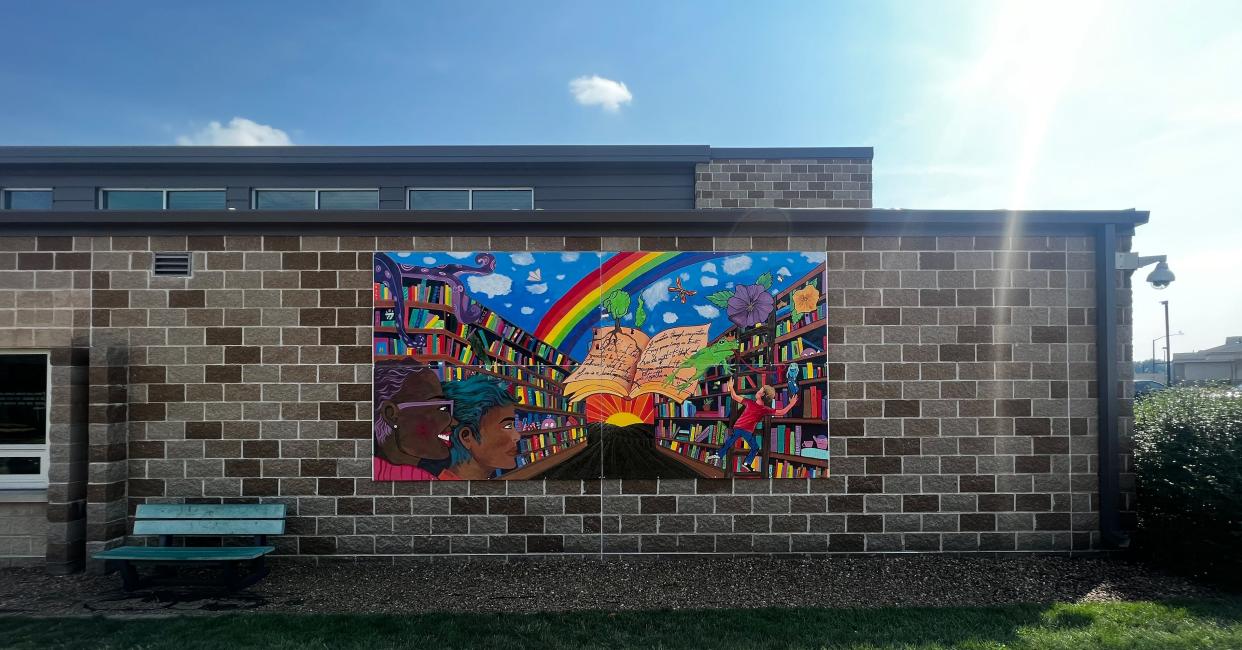 The portable mural located at the North Liberty Library was created by youth artists Lauryn Essien, Gigi Goodvin, Malia Parker, and Catie Vest.