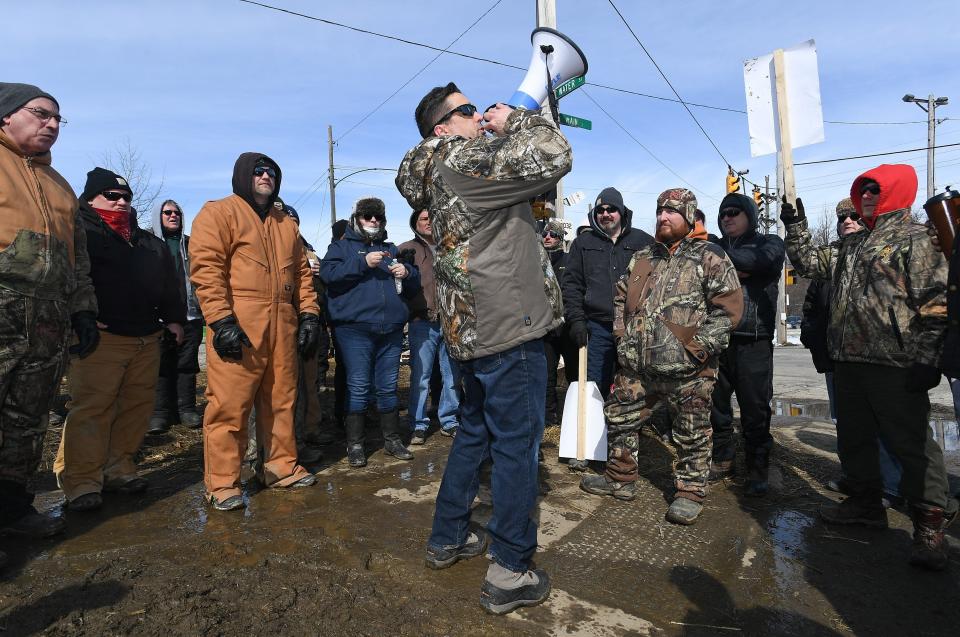 Scott Slawson, center, president of Local 506 of the United Electrical. Radio and Machine Workers at Wabtec, uses a bullhorn to talk to striking workers on March 1, 2019. As negotiations between the union and Wabtec begin April 27, Slawson said he's hoping the two parties can come to terms.