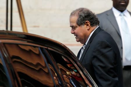 U.S. Supreme Court Justice Antonin Scalia departs following the Red Mass, a service to mark the beginning of this year's Supreme Court term, at the Cathedral of St. Matthew the Apostle in Washington October 5, 2014. The Red Mass is sponsored each year by the John Carroll Society, a Roman Catholic organization for professionals in law and business in Washington. REUTERS/Jonathan Ernst (UNITED STATES - Tags: POLITICS CRIME LAW RELIGION) - RTR490ME