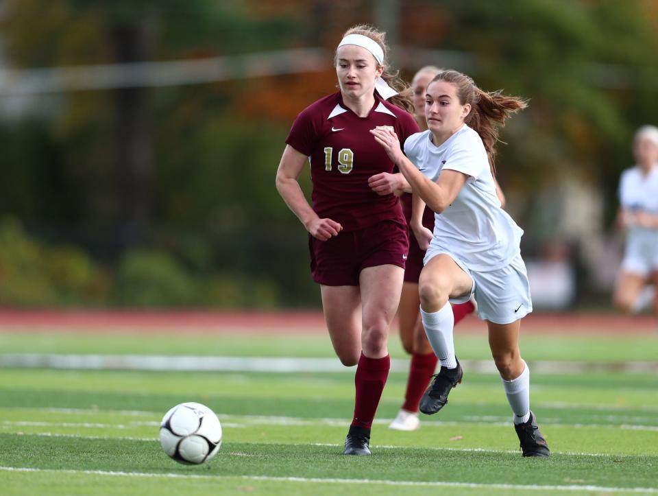 Arlington Kaylee Stowell (19) and John Jay-East Fishkill's Ava Jordan (35) fight for possession during in the girls Section 1 Class AA soccer championship game at Nyack High School on Sunday, October 31, 2021. 