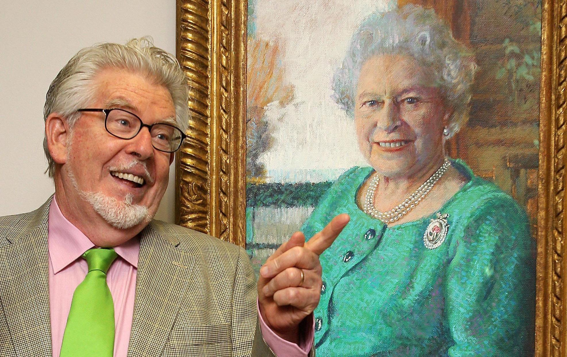 File photo dated 30/06/20 of Rolf Harris posing next to his portrait of Queen Elizabeth II as he celebrates 65 years in art as he opened his A Life in Art' exhibition at the Clarendon Fine Art Gallery, London. The disgraced entertainer and convicted sex offender has died at the age of 93, a registrar at Maidenhead Town Hall has confirmed to the PA news agency. Issue date: Tuesday May 23, 2023.