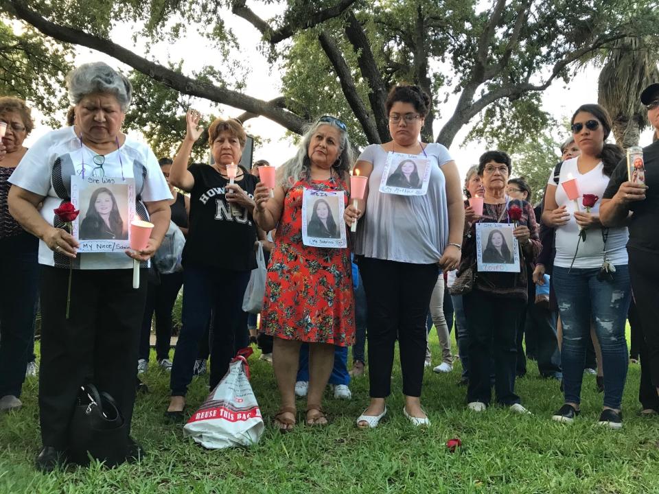 Dozens of family members and friends of four women who authorities say were killed by a U.S. Border Patrol agent gather for a candlelight vigil at a park in downtown Laredo, Texas, on Tuesday, Sept. 18, 2018. Juan David Ortiz was arrested Saturday while hiding in a hotel parking garage. Investigators believe he fatally shot the four victims during separate attacks after taking each of them to desolate areas outside of Laredo. Investigators say a fifth victim escaped and contacted authorities. (AP Photo/Susan Montoya Bryan)