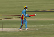 A member of ground staff removes wickets in the Pindi Cricket Stadium following cancel of 1st one day international cricket match between Pakistan and New Zealand, in Rawalpindi, Pakistan, Friday, Sept. 17, 2021. The limited-overs series between Pakistan and New Zealand has been postponed due to security concerns of the Kiwis. (AP Photo/Anjum Naveed)