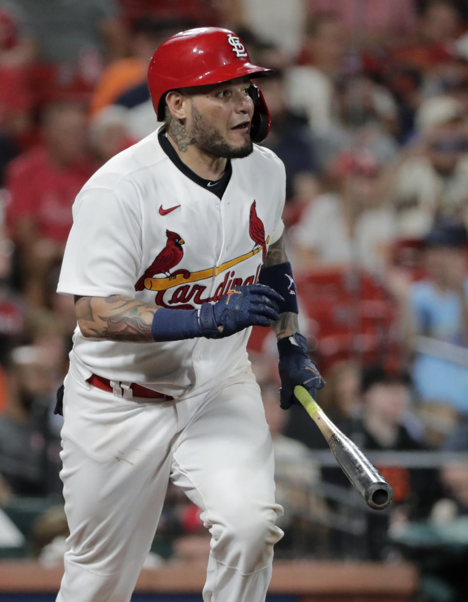 St. Louis Cardinals' Yadier Molina carries the bat to first after driving a single to center in the seventh inning of a baseball game against the San Francisco Giants, Friday, July 16, 2021, in St. Louis. The single was Molina's 2065th career hit, moving him into fifth place, past Enos Slaughter, on the Cardinals' all-time hit list. (AP Photo/Tom Gannam)