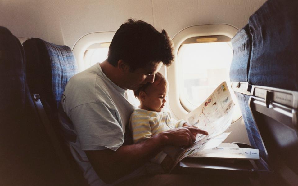 Father and baby on plane