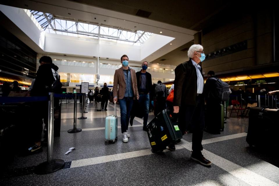 Passengers wear masks at the International flights terminal of the Los Angeles Airport, in Los Angeles, California, USA, 13 April 2022. (EPA)