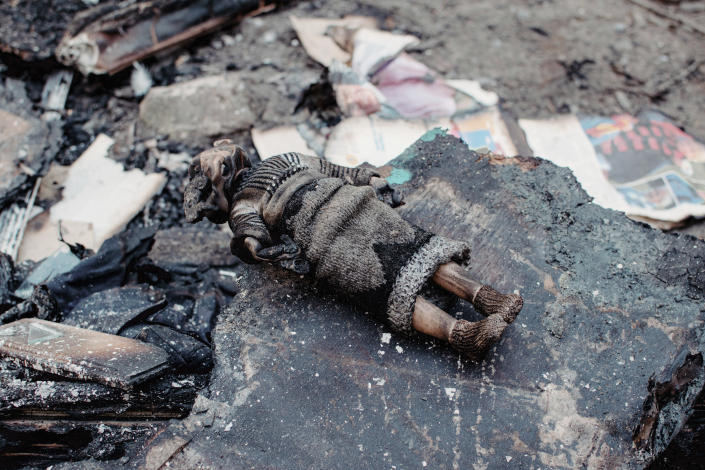 A view of a burned doll in a yard of a residential building damaged by shelling, in Chernihiv, Ukraine, Wednesday, March 9, 2022. (AP Photo/Yuriy Vasilenko)