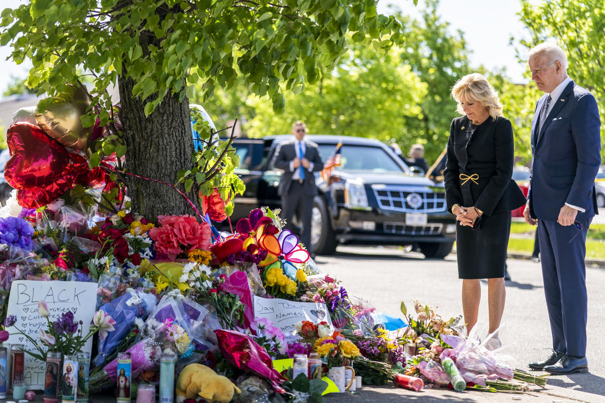President Joe Biden and first lady Jill Biden pay their respects to the victims of Saturday's shooting at a memorial across the street from the TOPS Market in Buffalo, N.Y., on May 17, 2022. (Andrew Harnik / AP)