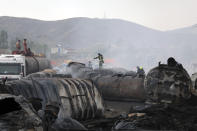 Firefighters work to extinguish a burning fuel tanker in Kabul, Afghanistan, Sunday, May 2, 2021. A fire roared through several fuel tankers on the northern edge of the Afghan capital late Saturday, injuring at least 10 people and plunging much of the city into darkness, officials said. (AP Photo/Rahmat Gul)