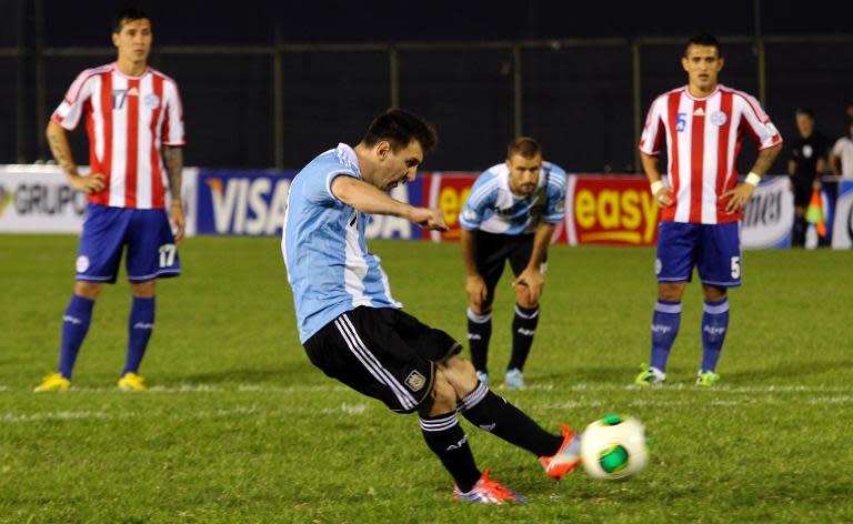 Lionel Messi kicks a penalty to score against Paraguay during their World Cup Brazil 2014 South American qualifying football match in Asuncion on September 10, 2013