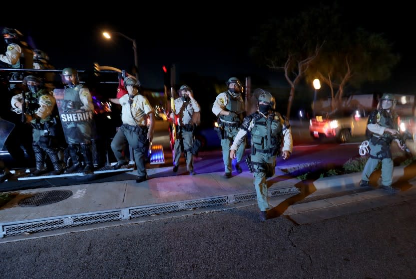 WEST HOLLYWOOD, CA - SEPT. 25, 2020. Los Angeles County Sheriff's Department deputies deploy to disperse Black Lives Matter protesters marching in West Hollywwod on Friday night, Sept. 25, 2020, calling for justice for Breonna Taylor. (Luis Sinco / Los Angeles Times)