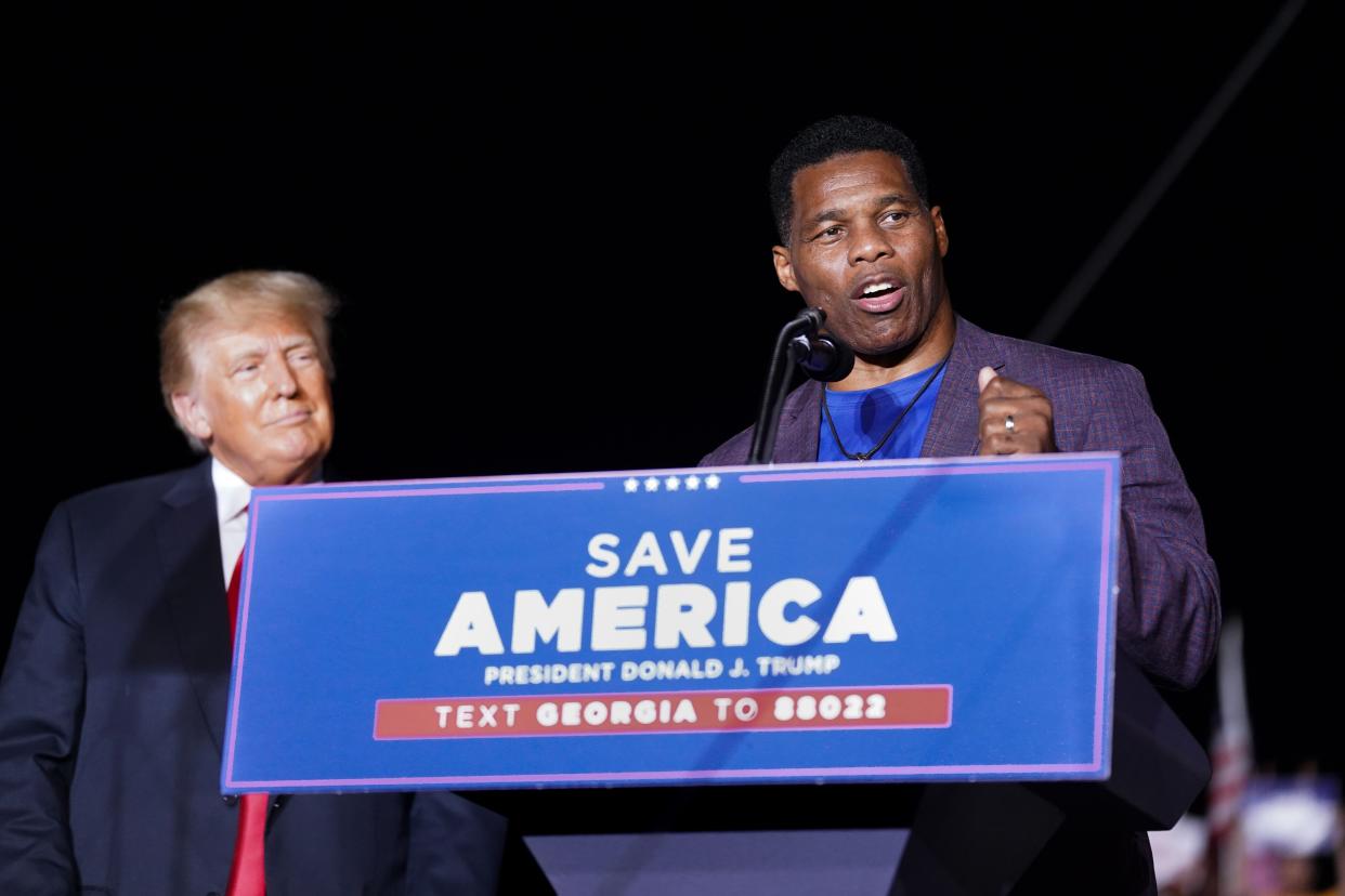 Republican Senate candidate Herschel Walker, right, speaks at a rally with former President Donald Trump on September 25, 2021 in Perry, Georgia.